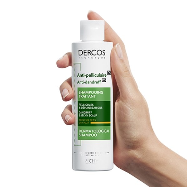 Eine Hand hält das Dercos Anti-Schuppen Shampoo für trockenes Haar