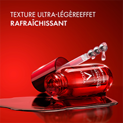 Sérum Vichy rouge avec pipette posé sur une surface brillante sur fond rouge, accompagné des mentions « Texture ultra-légère » et « Effet rafraîchissant ».